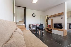 a living room with a couch and a table with chairs at Smiljana apartments Klimno in Klimno