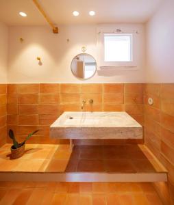 a bathroom with a large sink and a mirror at Can Jove Cadaqués in Cadaqués