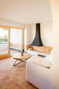 a living room with a white couch and a table at Can Jove Cadaqués in Cadaqués