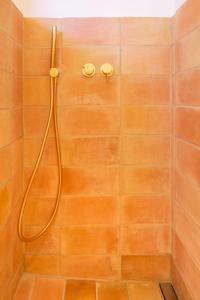 a shower with a hose in a bathroom at Can Jove Cadaqués in Cadaqués