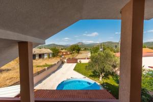 a view from the balcony of a house with a swimming pool at Villa Vadian & Pool in Gevgelija