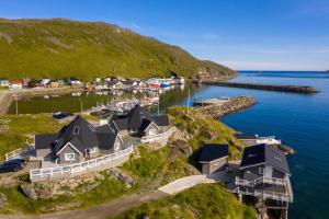 an aerial view of a house on a hill next to the water at Cape Marina Lodge in Skarsvåg