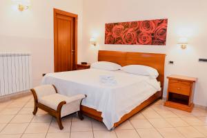 a bedroom with a bed with a table and chairs at Hotel Ristorante Garibaldi in Frosinone