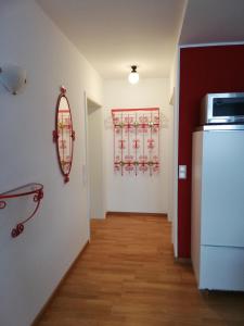 a room with a refrigerator and a mirror on the wall at Barrierefreies Appartement auf der Alb in Trochtelfingen