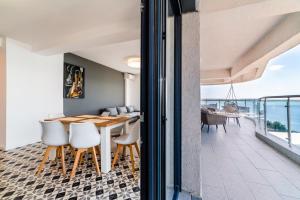 une salle à manger avec une table et des chaises et l'océan dans l'établissement Seaside by Casa del Mar, à Mamaia