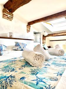 a bedroom with a bed with towels on it at COZY LOFT MARINA VIEW in Savona