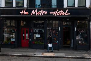 a person standing in front of a store on a sidewalk at The Metro Hotel in San Francisco