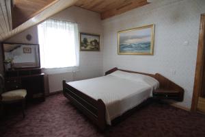 a bedroom with a bed and a window at Vila Saulute in Palanga