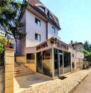 a building with a hotel sign in front of it at Family Art Hotel Gallery in Pleven