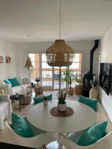 a living room with a table and a couch at Beach Apartment Montemar No.1 - perfect ocean view in Sóller