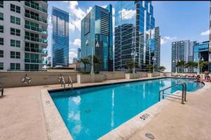 a large swimming pool in a city with tall buildings at Spectacular Studio at Brickell, Free Parking in Miami