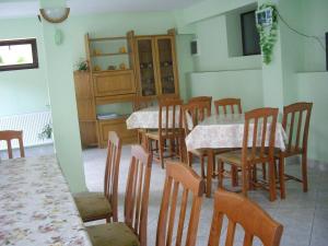 a dining room with tables and chairs and a kitchen at Villa Shipkovo in Shipkovo +20 photos