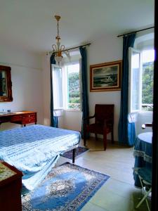 une chambre avec un lit, une chaise et des fenêtres dans l'établissement VILLA MONICA Diano San Pietro (IM) Italy, à Diano San Pietro