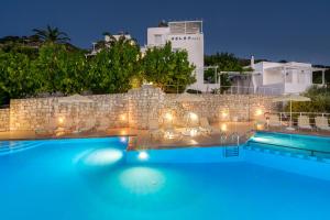 a view of a swimming pool at night at Eolos Apartments in Chania Town