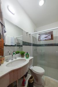a bathroom with a sink and a toilet and a shower at Pousada Casario in Paraty