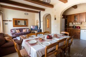 a dining room with a table and a kitchen at Mandolina Casa in Għarb