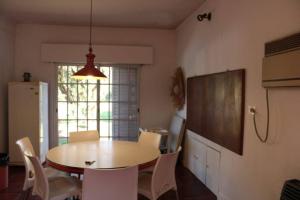a dining room with a table and chairs and a window at Casa Quinta Marie Rose in Mercedes
