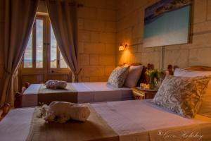 A bed or beds in a room at Orchidea Xaghra
