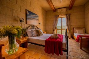 A bed or beds in a room at Orchidea Xaghra