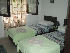 two beds in a hotel room with towels on them at Apartments Matkovic in Kotor