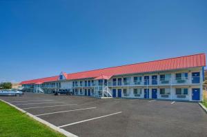 a large building with a parking lot in front of it at Motel 6-Baker City, OR in Baker City