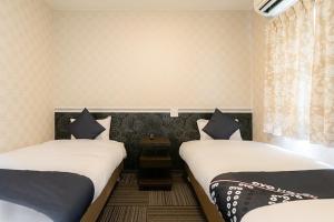 Postel nebo postele na pokoji v ubytování Hotel Sunmarine