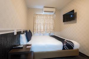 Postel nebo postele na pokoji v ubytování Hotel Sunmarine