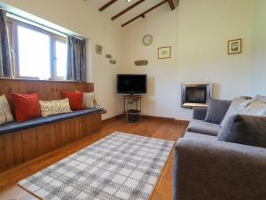 a living room with a couch and a tv at The Proven House in Preston
