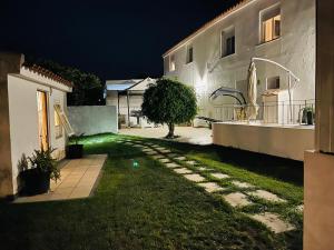een tuin van een huis 's nachts met groen licht bij Kerart Lima in Armação de Pêra