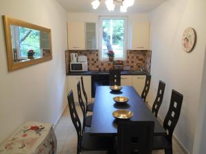a dining room with a table and chairs and a kitchen at Apartment MB in Rijeka