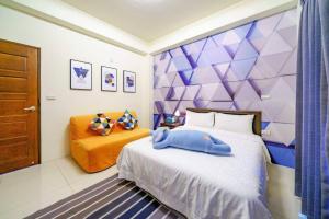a bedroom with a large bed with a purple wall at Jenny Inn in Wujie