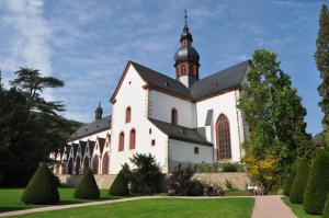 a white church with a black roof at Hotel Gasthof Schuster und Gästehaus in Rüdesheim am Rhein