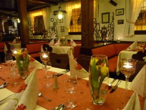 a table with wine glasses on it in a restaurant at Hotel Gasthof Schuster und Gästehaus in Rüdesheim am Rhein