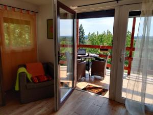 a room with a sliding glass door leading to a balcony at Krisztina Vendégház Leányfalu - Különálló - itt csak Ti vagytok in Leányfalu