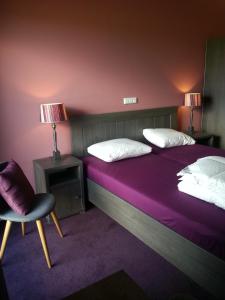 En eller flere senger på et rom på Hotel Boerderij Restaurant De Gloepe