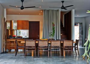 a kitchen and dining room with a table and chairs at Villa Ziba in Seminyak