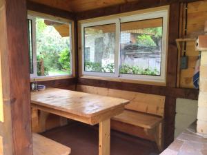a room with a wooden table and two windows at Квартира in Yaremche