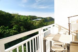 a balcony with chairs and a view of the ocean at Miranda A 609 Pico De Loro Beach and country club by SEE condominium rentals in Nasugbu