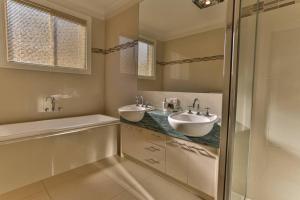 a bathroom with two sinks and a shower at Ventnor Escape in Style in Ventnor