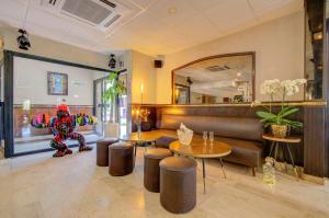 a room with a couch and tables and a stuffed animal at Eurotel Parc Expo Airport Montpellier in Pérols