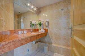 a bathroom with a sink and a mirror at Eurotel Parc Expo Airport Montpellier in Pérols