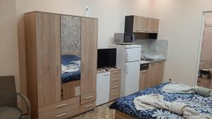a bedroom with a bed and a dresser with a mirror at АРт 1 in Sliven