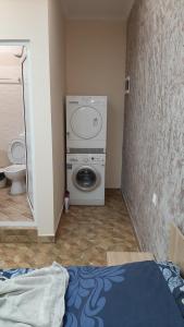 a room with a washing machine in a bathroom at АРт 1 in Sliven