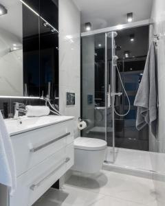 a bathroom with a sink and a toilet and a shower at ZGODA 13 P&O Serviced Apartments in Warsaw