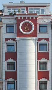 a large red building with a clock on it at Hotel Bazaar in Istanbul
