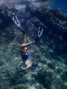 a person is swimming in the water with clubs at Vacation home, Ferienhaus KLAUDIA in Kraj, Mošćenička Draga near Opatija in Mošćenička Draga