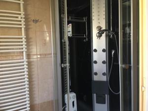 a shower in a bathroom with a glass door at Lavender in Hévíz +12 photos