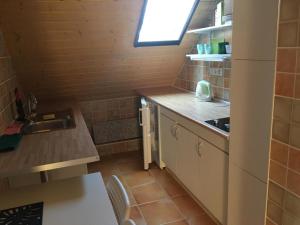 a small kitchen with a sink and a counter at Lavender in Hévíz