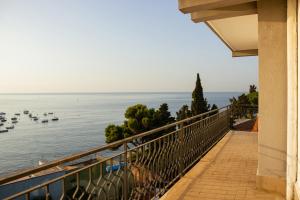 a balcony with a view of the water and boats at Wave Hotel in Acireale