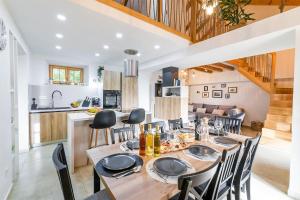 a dining room with a table and chairs and a kitchen at Villa Humac Hvar in Poljica